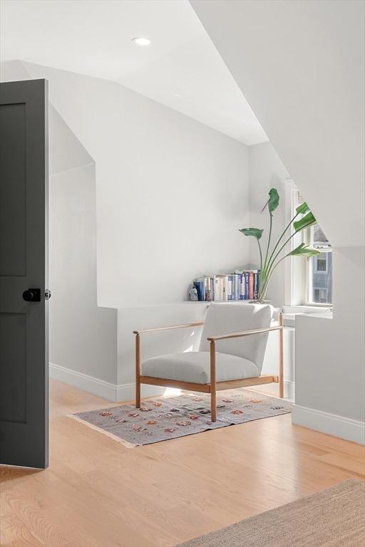 office featuring baseboards, wood finished floors, and vaulted ceiling