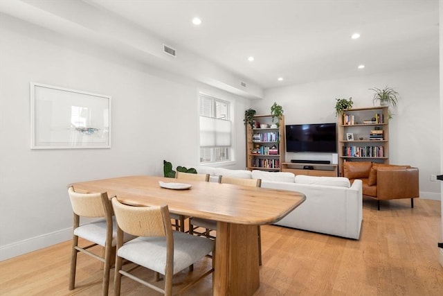 dining area with light wood-type flooring, recessed lighting, and baseboards