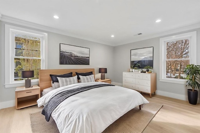 bedroom with crown molding and light wood-type flooring