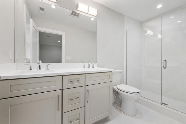 bathroom featuring tile patterned floors, vanity, toilet, and walk in shower