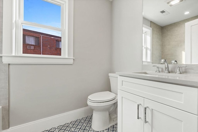 bathroom with tile patterned flooring, vanity, and toilet