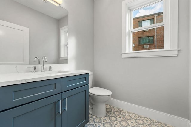 bathroom featuring tile patterned flooring, vanity, and toilet