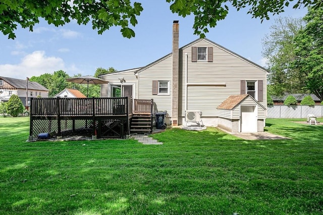 back of property with a wooden deck, a chimney, and a cooling unit