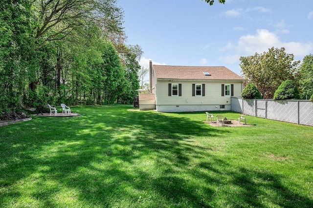 back of property featuring an outdoor fire pit and a chimney