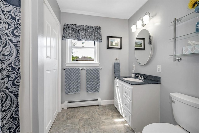 bathroom featuring a baseboard radiator, toilet, baseboards, vanity, and stone finish flooring