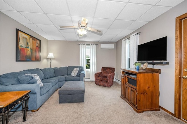 living room with an AC wall unit, a drop ceiling, light carpet, a ceiling fan, and baseboard heating