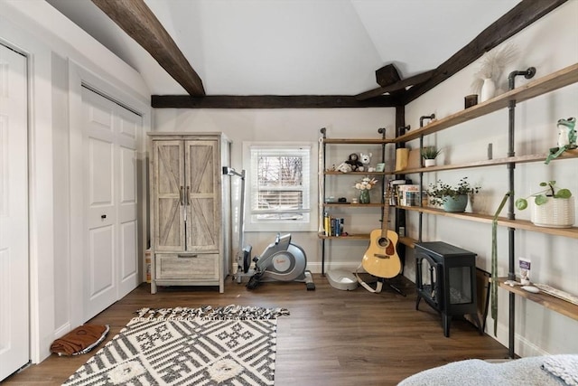 interior space featuring dark hardwood / wood-style floors and lofted ceiling with beams