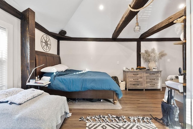 bedroom featuring lofted ceiling with beams and hardwood / wood-style floors