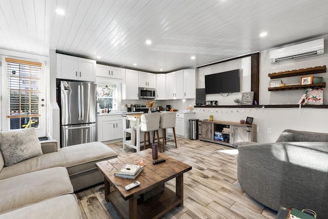 living room featuring an AC wall unit, sink, wood ceiling, and light wood-type flooring