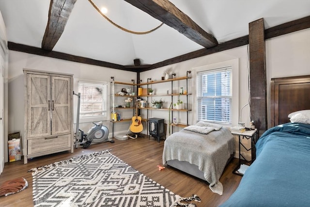 bedroom with vaulted ceiling with beams and hardwood / wood-style floors