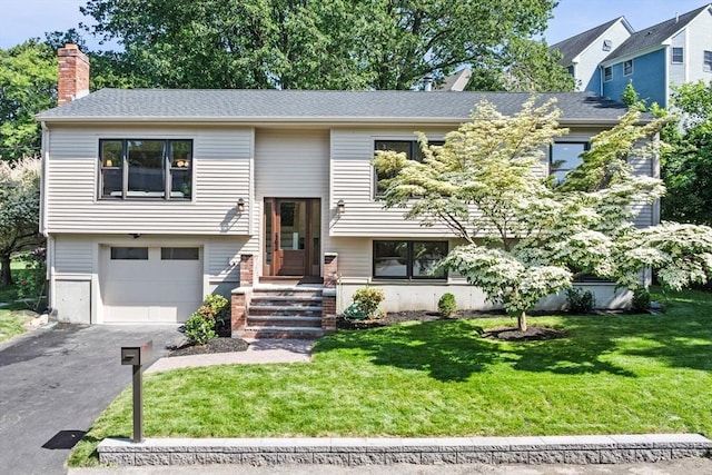 1 Archer St, Swampscott, MA 01907 - split foyer home with a front yard, a garage, asphalt driveway, and a chimney