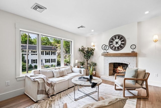 1 Archer St, Swampscott, MA 01907 - living room with a brick fireplace, wood finished floors, and recessed lighting