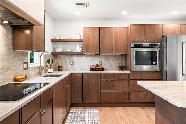 1 Archer St, Swampscott, MA 01907 - kitchen with appliances with stainless steel finishes, wall chimney range hood, light wood-style flooring, backsplash, and open shelves