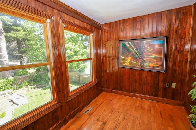 88 Biltmore St, Springfield, MA 01108 - empty room featuring wooden walls, light wood-style flooring, and healthy amount of natural light