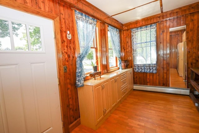 88 Biltmore St, Springfield, MA 01108 - doorway to outside with a baseboard radiator, healthy amount of natural light, wooden walls, and light wood-style floors