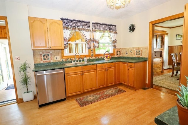 88 Biltmore St, Springfield, MA 01108 - kitchen with stainless steel dishwasher, light wood-type flooring, dark countertops, decorative backsplash, and a chandelier