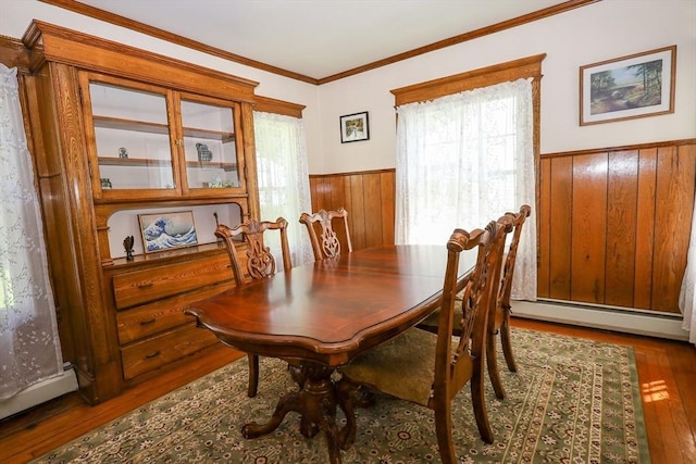88 Biltmore St, Springfield, MA 01108 - dining room with wainscoting, hardwood / wood-style flooring, a baseboard radiator, wood walls, and plenty of natural light
