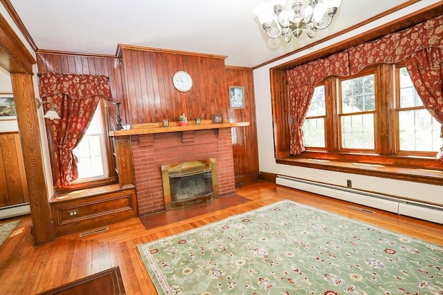 88 Biltmore St, Springfield, MA 01108 - unfurnished living room with plenty of natural light, a chandelier, wooden walls, wood finished floors, and ornamental molding