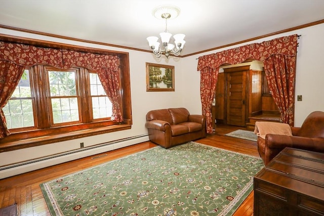 88 Biltmore St, Springfield, MA 01108 - living room featuring a chandelier, baseboard heating, wood finished floors, and ornamental molding