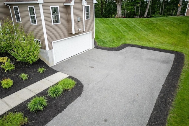 9 Gideon Ln, Shirley, MA 01464 - view of patio / terrace with an attached garage and asphalt driveway