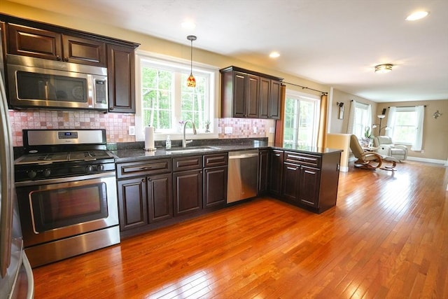 9 Gideon Ln, Shirley, MA 01464 - kitchen featuring appliances with stainless steel finishes, a sink, open floor plan, plenty of natural light, and recessed lighting