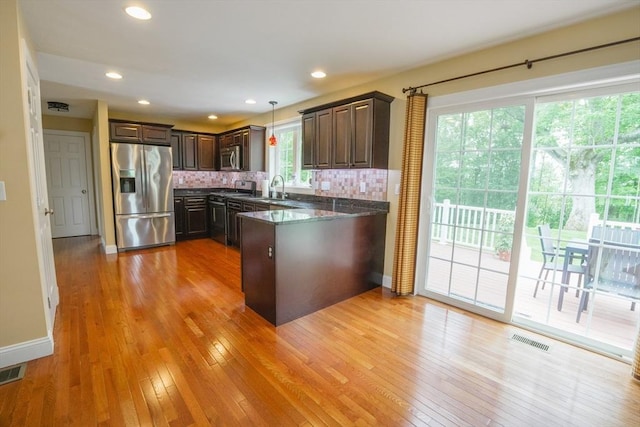 9 Gideon Ln, Shirley, MA 01464 - kitchen featuring appliances with stainless steel finishes, a sink, a peninsula, dark brown cabinetry, and backsplash