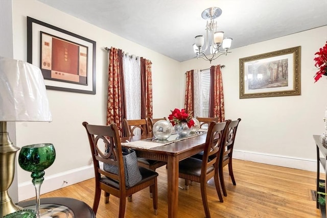 dining room with a notable chandelier and hardwood / wood-style flooring