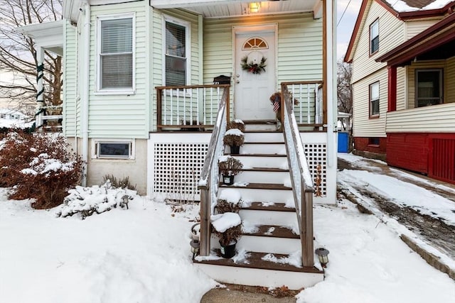 view of snow covered property entrance