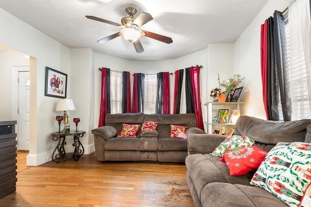 living room featuring ceiling fan, a healthy amount of sunlight, and light wood-type flooring