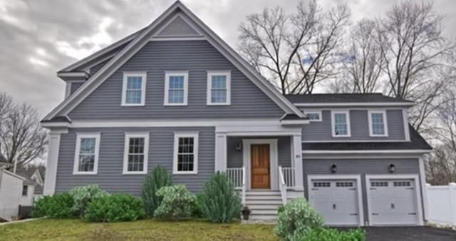 41 Pleasant St, Holliston, MA 01746 - view of front of house featuring a garage, asphalt driveway, and a front lawn