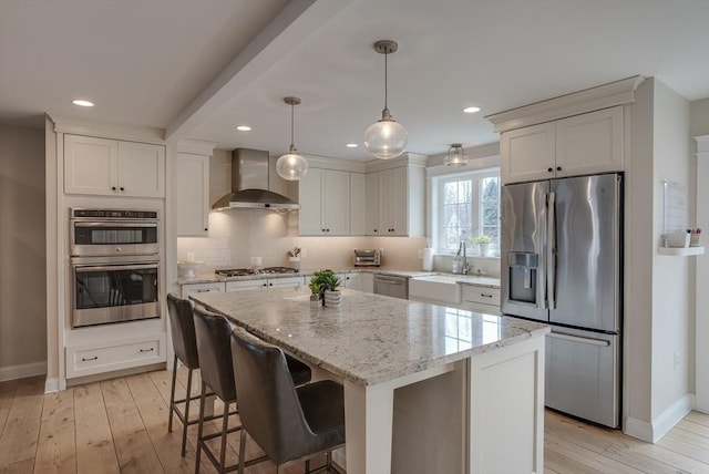 41 Pleasant St, Holliston, MA 01746 - kitchen featuring wall chimney range hood, appliances with stainless steel finishes, baseboards, a center island, and recessed lighting