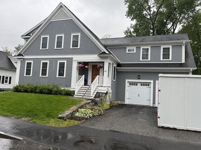 41 Pleasant St, Holliston, MA 01746 - view of front of home with an attached garage, a front yard, roof with shingles, and asphalt driveway