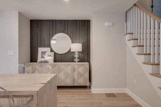 41 Pleasant St, Holliston, MA 01746 - dining space featuring light wood-style flooring, baseboards, and stairway