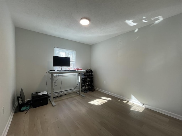 interior space featuring a textured ceiling and light wood-type flooring