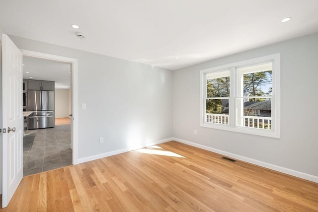 spare room featuring hardwood / wood-style flooring