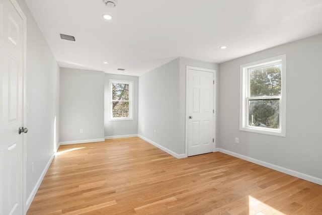 unfurnished room with light wood-type flooring