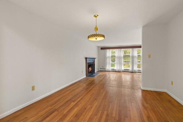 9 Flagg Rd, Acton, MA 01720 - unfurnished living room with baseboards, hardwood / wood-style floors, and a fireplace with flush hearth