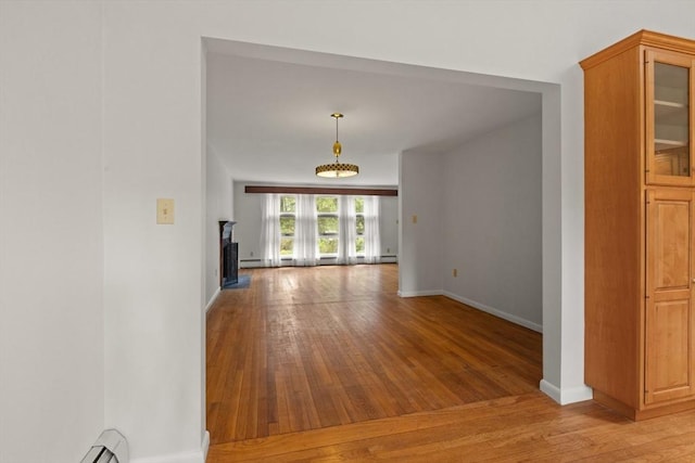 9 Flagg Rd, Acton, MA 01720 - unfurnished room featuring light wood-style floors, baseboards, and a fireplace with raised hearth