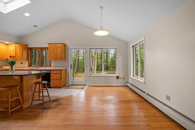 9 Flagg Rd, Acton, MA 01720 - kitchen with a baseboard heating unit, dishwasher, lofted ceiling, a skylight, and a breakfast bar