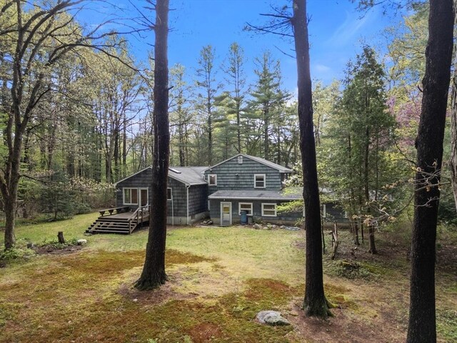 9 Flagg Rd, Acton, MA 01720 - view of front of house with a wooden deck and a front yard