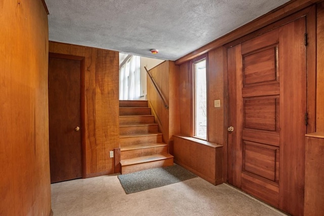 9 Flagg Rd, Acton, MA 01720 - stairway featuring plenty of natural light, wood walls, and a textured ceiling