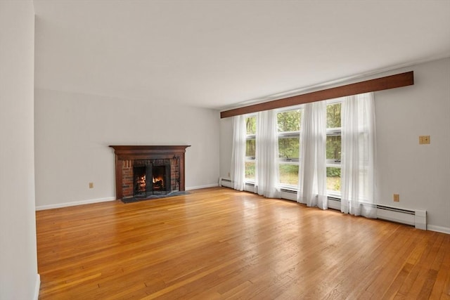 9 Flagg Rd, Acton, MA 01720 - unfurnished living room with light wood-type flooring, a brick fireplace, and baseboards