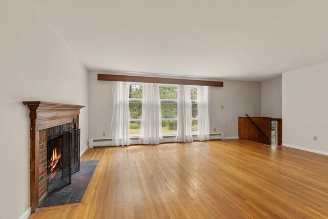 9 Flagg Rd, Acton, MA 01720 - unfurnished living room with a tile fireplace, light wood-style flooring, a baseboard radiator, and baseboards
