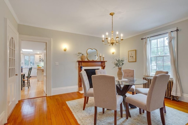 dining space featuring crown molding and light hardwood / wood-style floors