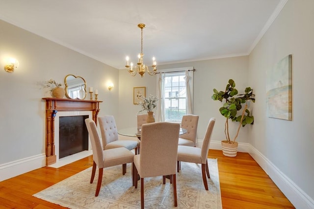 dining area featuring hardwood / wood-style flooring, crown molding, and a chandelier