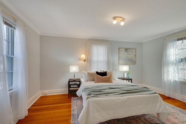 bedroom featuring crown molding and hardwood / wood-style floors