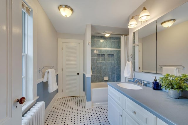 bathroom featuring vanity, radiator, and shower / tub combo