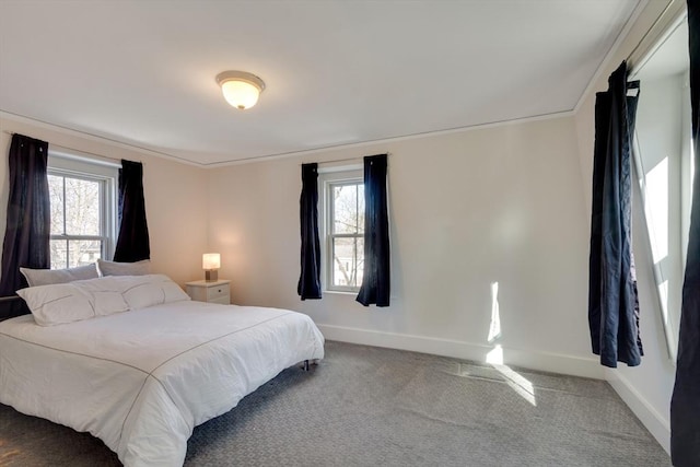 bedroom with ornamental molding, carpet floors, and multiple windows