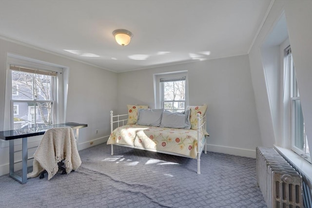 carpeted bedroom with multiple windows, crown molding, and radiator heating unit