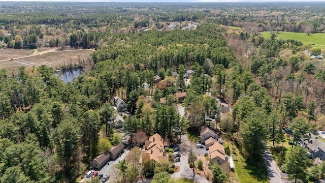birds eye view of property featuring a water view and a view of trees